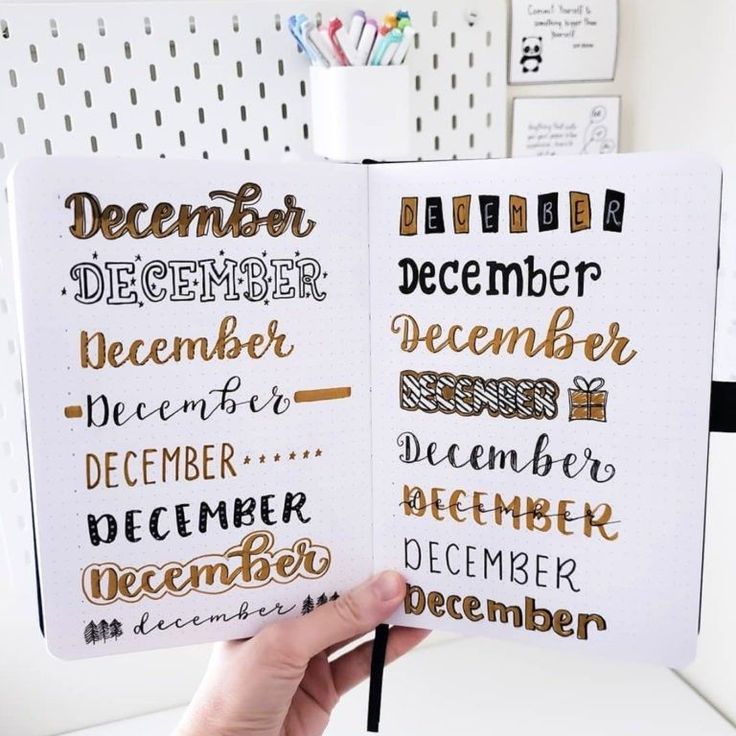 someone holding up a planner with the words december and december written on it in different languages