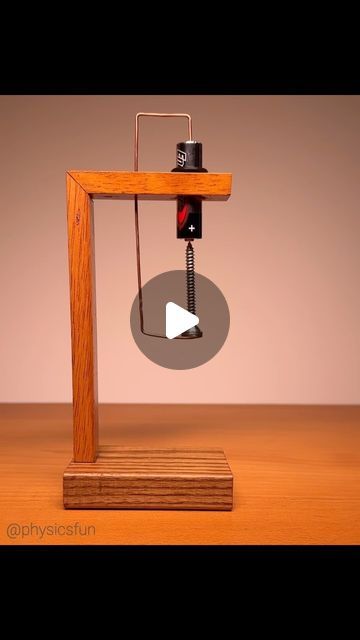 a wooden table with an electronic device on it's stand and a video player in the background