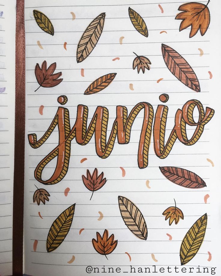 an open notebook with autumn leaves and the word june written in cursive writing