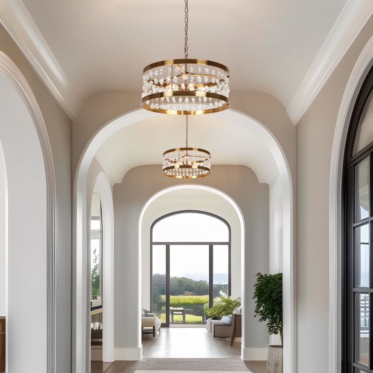 a large hallway with arched doorways and chandelier hanging from it's ceiling