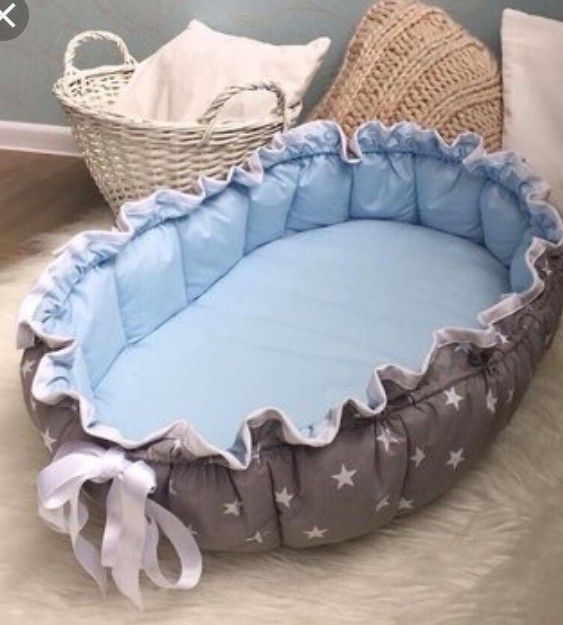 a blue and white pet bed with stars on it