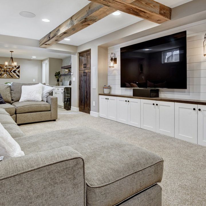 a living room filled with furniture and a large flat screen tv mounted on the wall