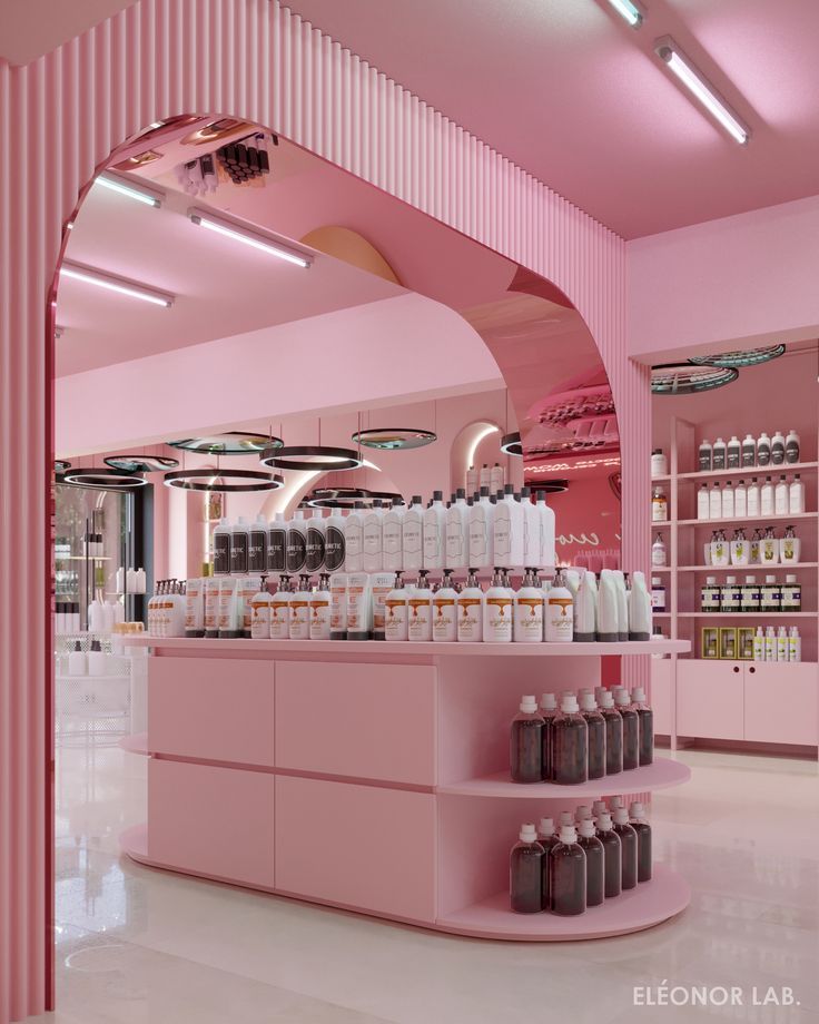 the interior of a store with pink walls and shelves filled with cosmetics products on display