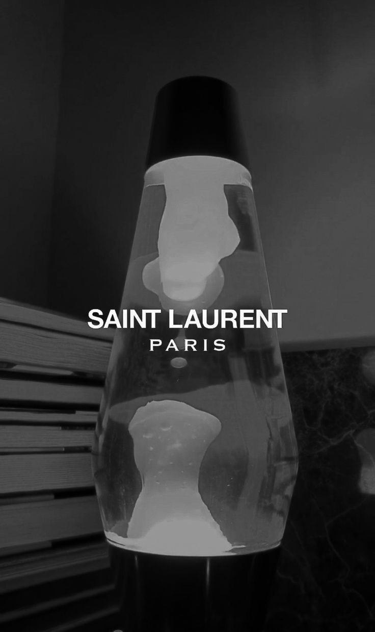 a black and white photo of a lamp with the words saint laurent paris on it