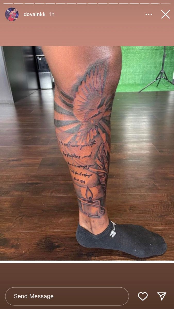 a man's leg with tattoos on it and a bird in the sky above him