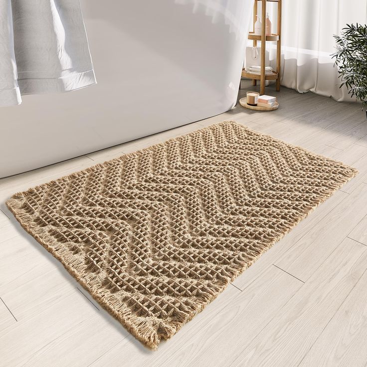 a bath tub sitting next to a rug on the floor