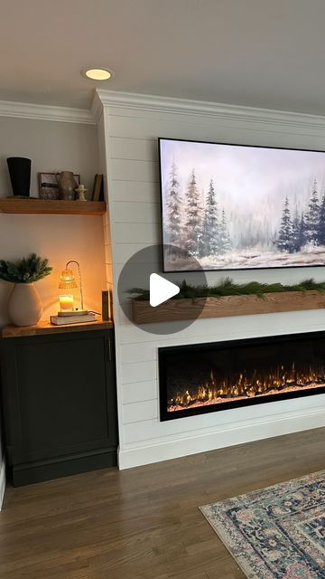 a flat screen tv mounted above a fireplace in a living room