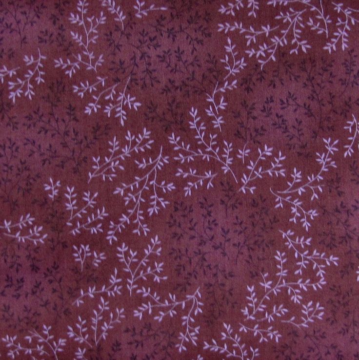 a close up view of a purple fabric with small white flowers on the top and bottom