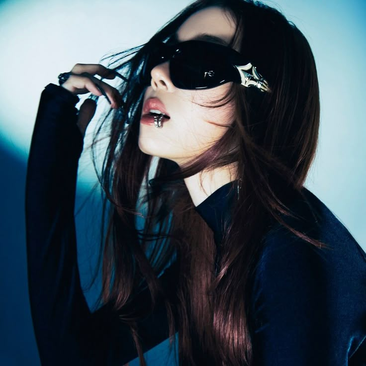 a woman with long hair and sunglasses on her head