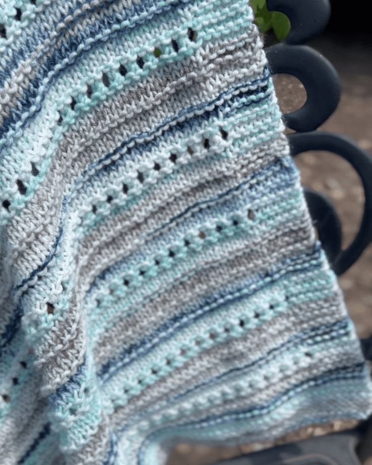 a crocheted blanket sitting on top of a chair