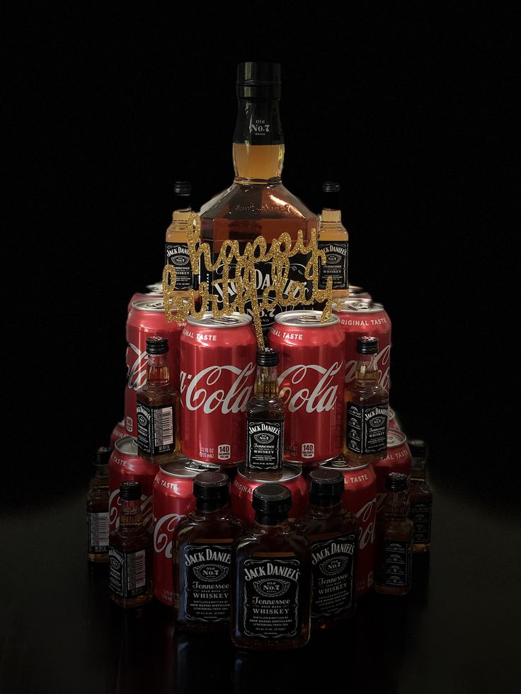 a stack of coca - cola cans with the word happy birthday spelled on them