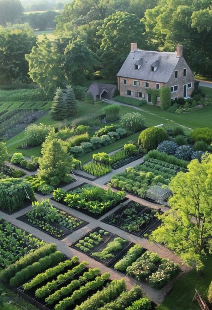 an aerial view of a large garden in front of a house with lots of trees