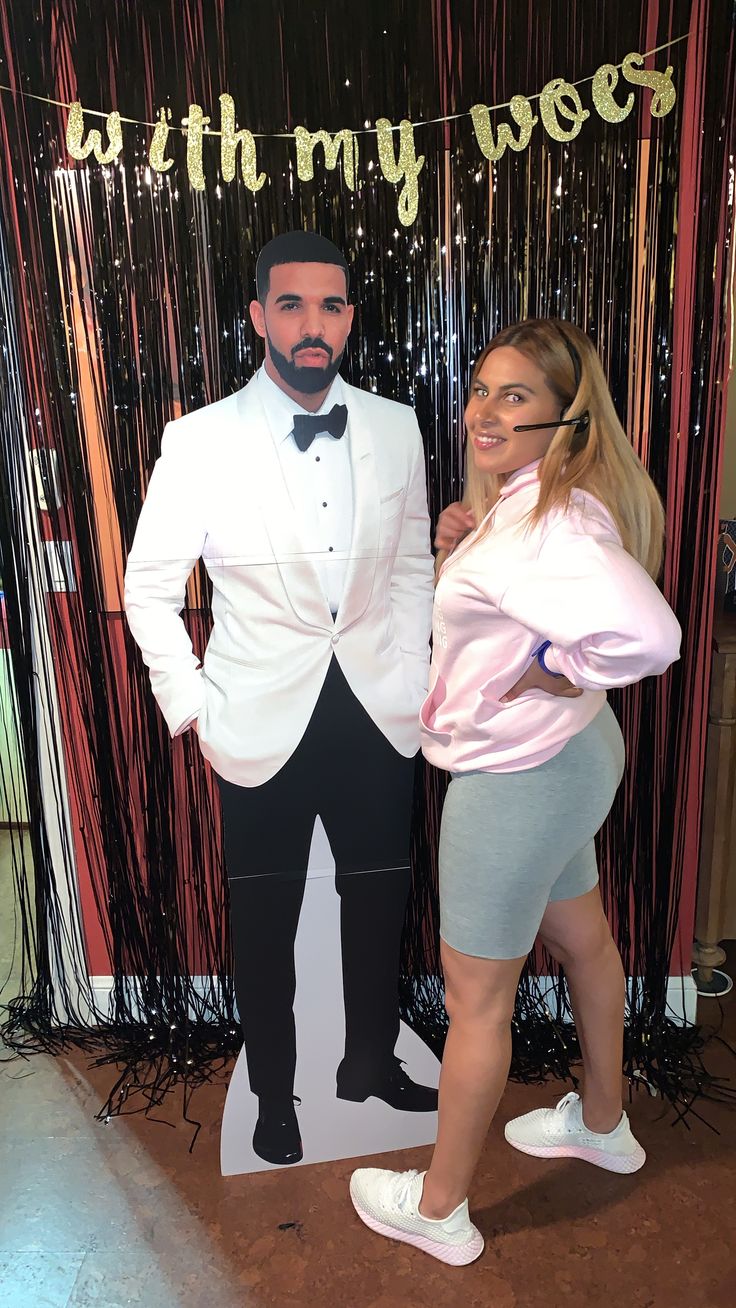 a man and woman posing for a photo in front of a backdrop that says with my wife