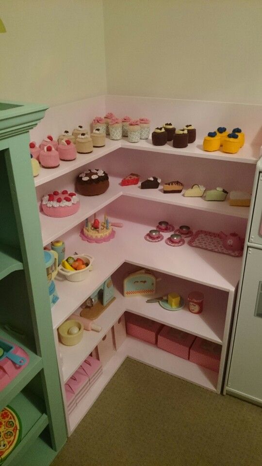 a room filled with lots of different types of cakes and cupcakes on shelves