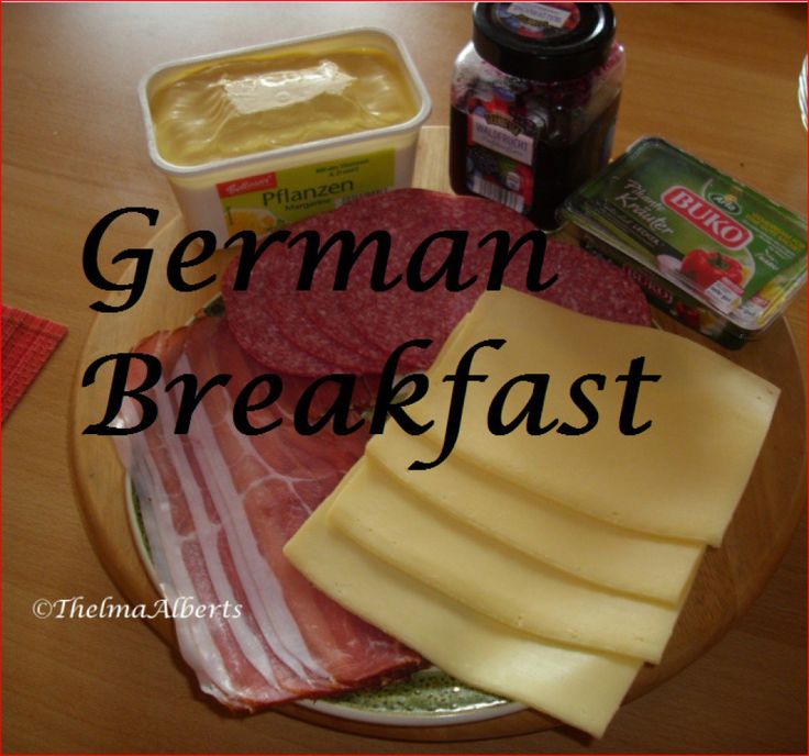 a plate with meat, cheese and sauces on it that says german breakfast in the middle