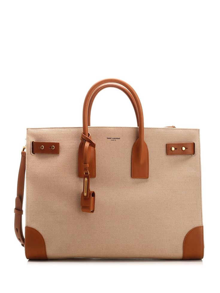 Large "Sac De Jour" bag in beige canvas and brown vegetable tanned leather from Saint Laurent, with side gussets, compression tabs, brass lock, adjustable and removable shoulder strap, two internal compartments divided by a removable zip pouch. Ysl 2024, Best Wallet, Woman Bags Handbags, Zip Pouch, Wallet Bag, Handle Bag, Bag For Women, Small Leather Goods, Vegetable Tanned Leather