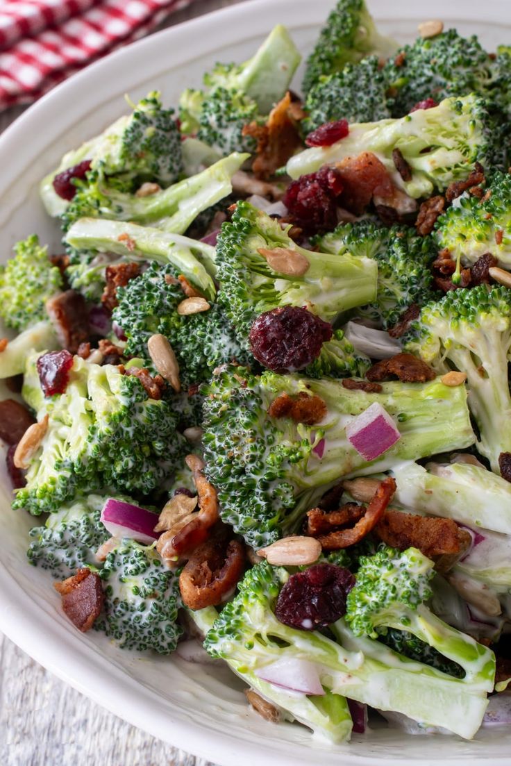 broccoli salad with cranberries and almonds in a white bowl