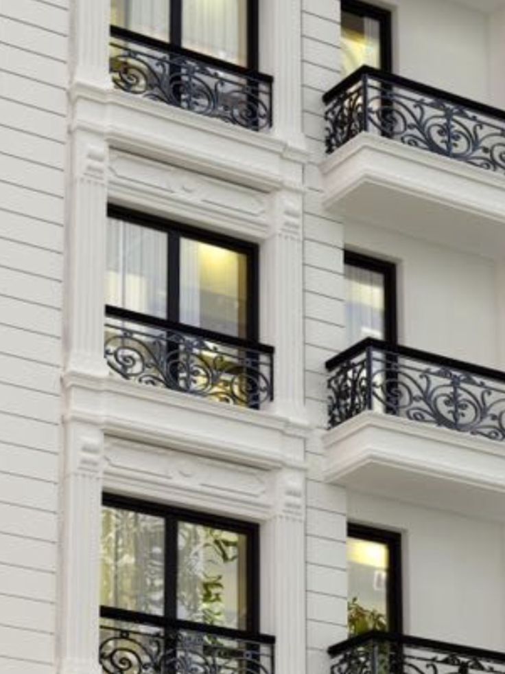 an apartment building with balconies and wrought iron balcony railings