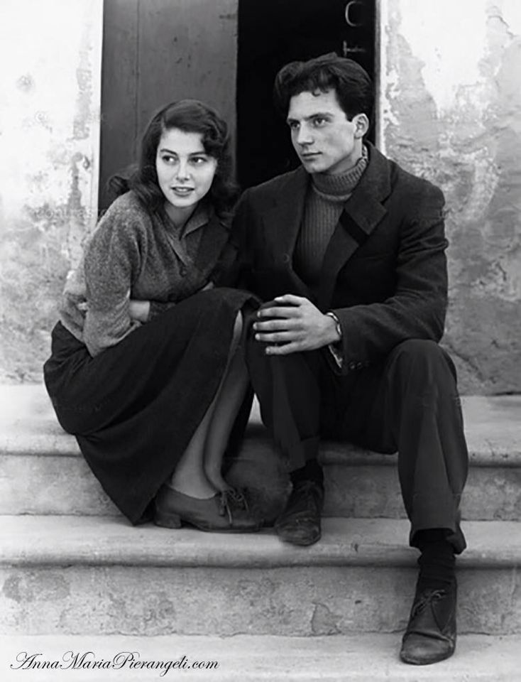 a man and woman sitting on steps next to each other