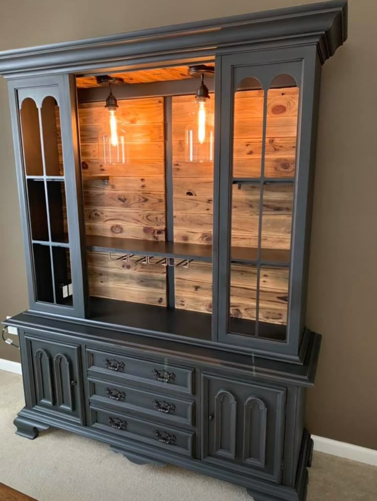 an old china cabinet with glass doors and drawers