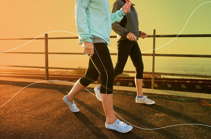 two people jogging on the road with ear buds in their ears