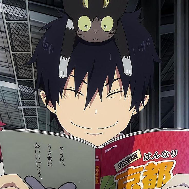 an anime character is reading a book with a cat on top of his head in front of him