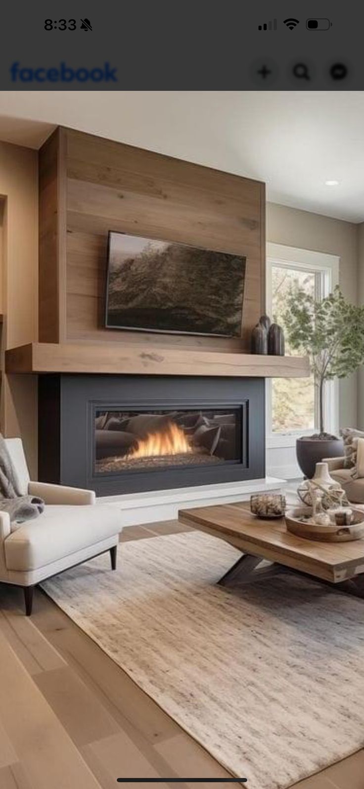 a living room filled with furniture and a flat screen tv mounted on the wall next to a fire place