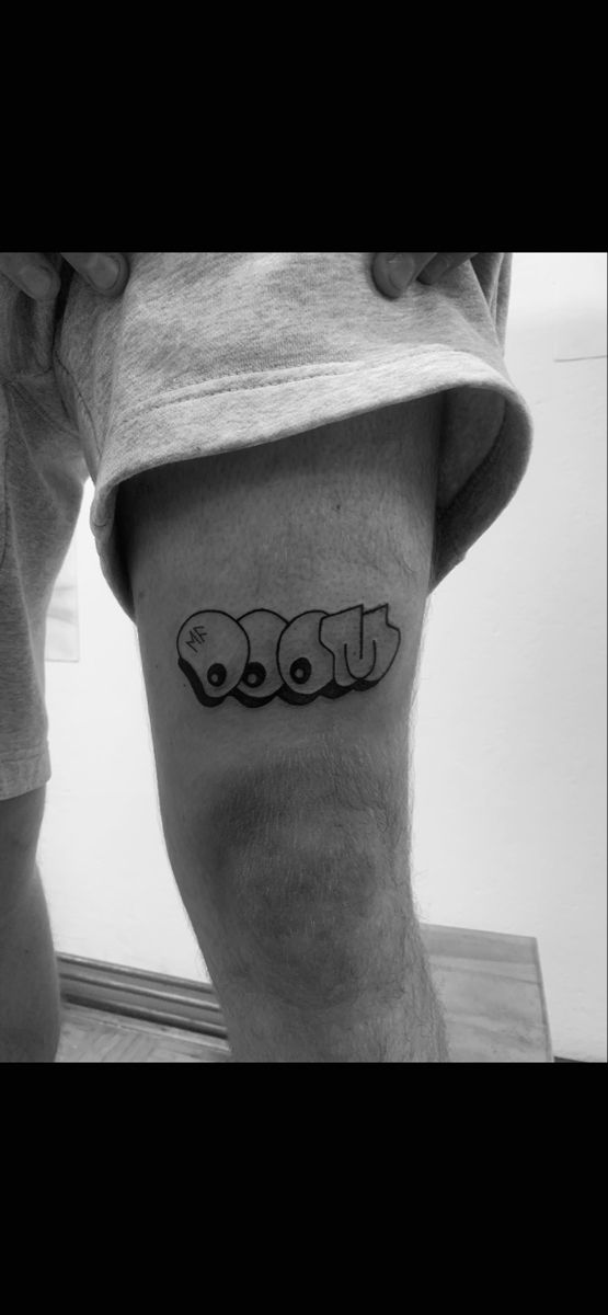 a man's leg with the word love tattooed on it