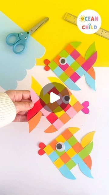 someone is cutting out some colorful paper fish