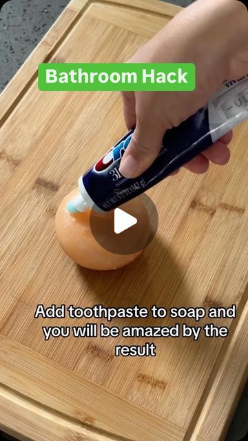 a person using an electric toothbrush on a wooden cutting board with text that reads, bathroom hack add toothpaste to soap and you will be amazed by the result