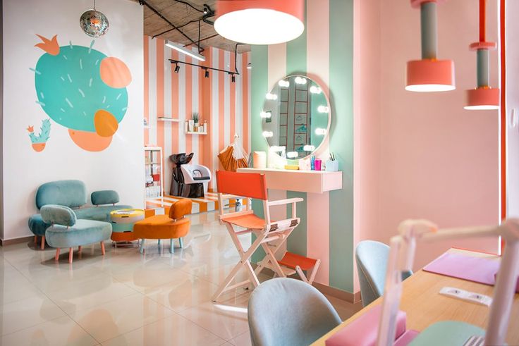 the interior of a salon with chairs, tables and mirrors