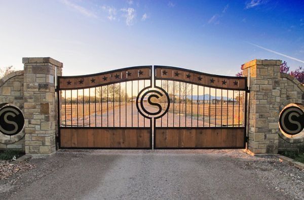 an image of a gated driveway with the letter s at it's center