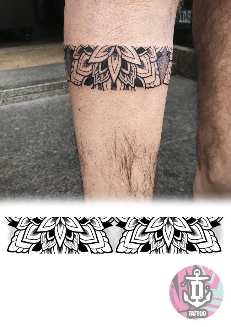 a man's leg with an intricate tattoo design on the lower part of his leg