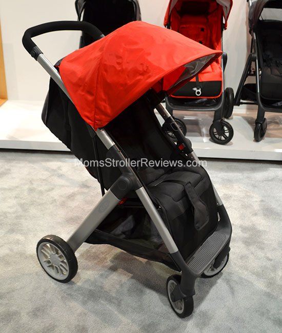 a stroller with a red cover on it's seat is shown in front of other strollers