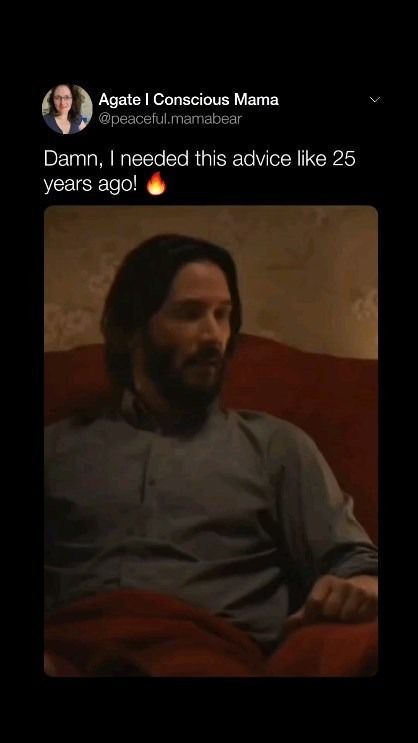 a man with long hair sitting on top of a couch