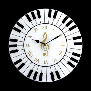 a white and black clock with musical notes on it