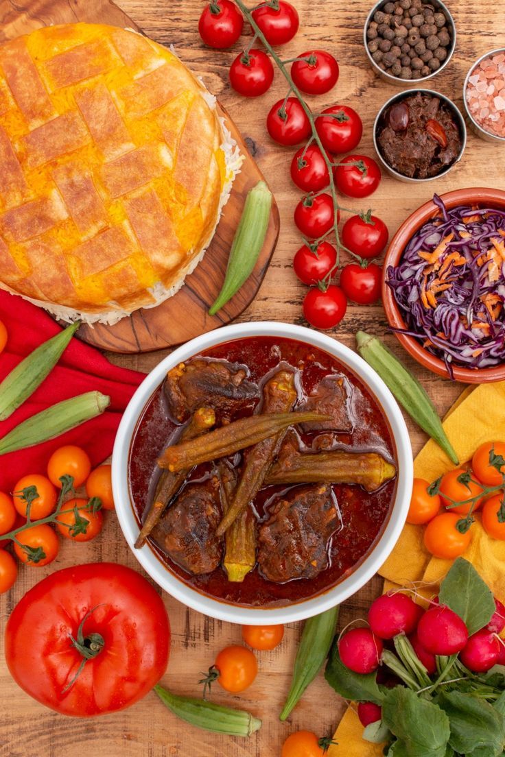 a table topped with lots of different types of food on top of a wooden table