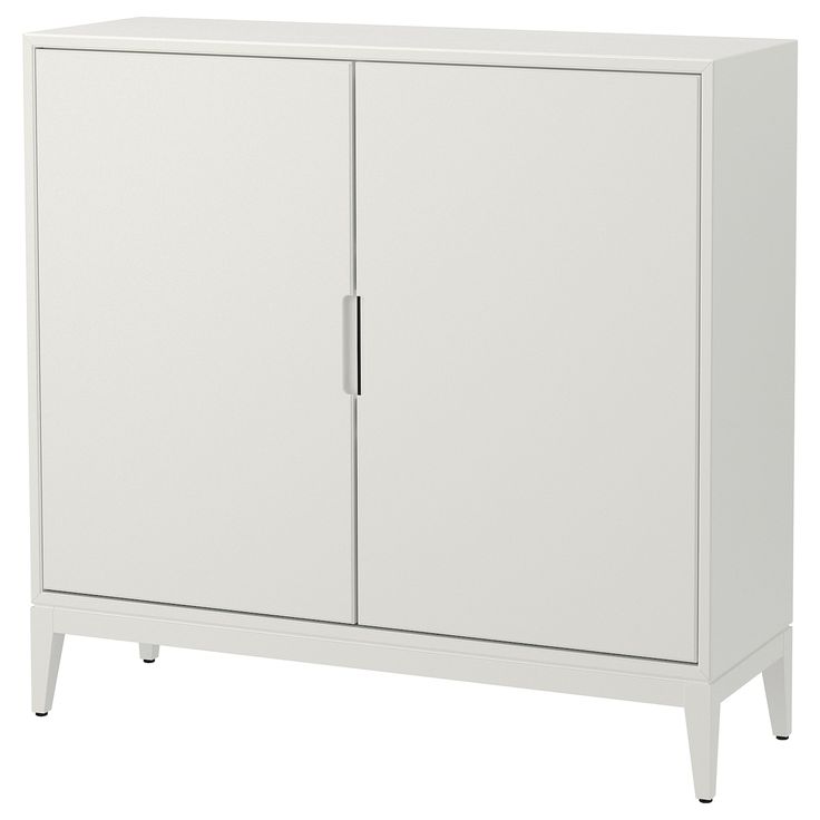 a white cabinet with two doors and legs