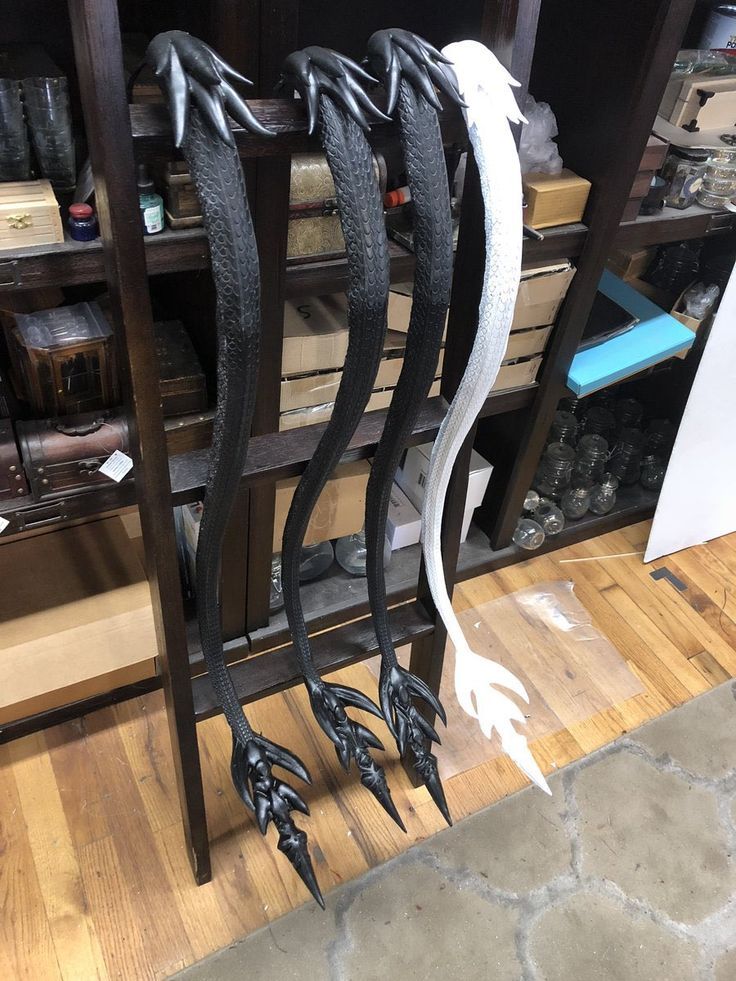 several black and white metal objects on display in a store or office area with wood flooring