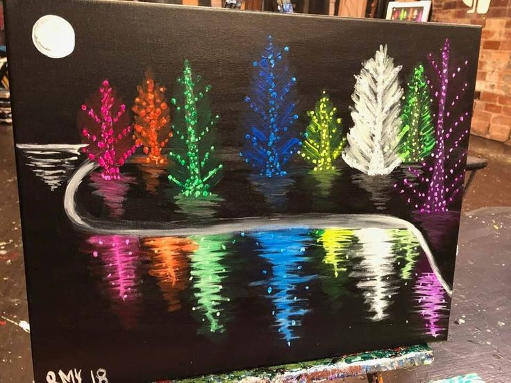 an easel painted with different colors of trees in the water and on it's sides