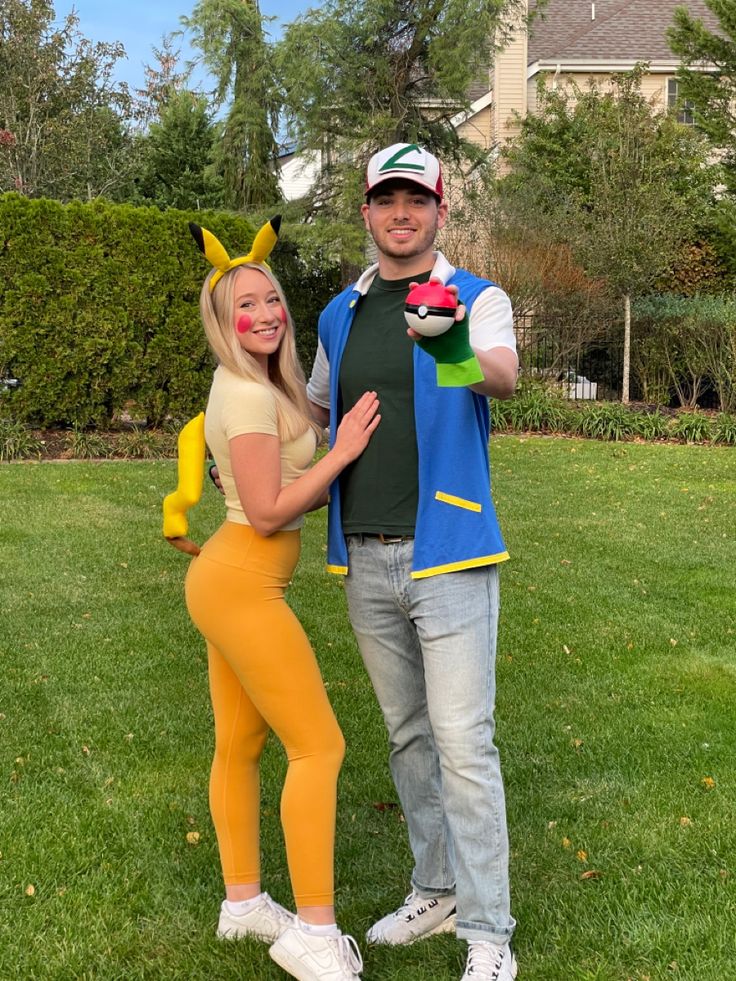 a man and woman dressed in pokemon costumes posing for a photo together on the lawn