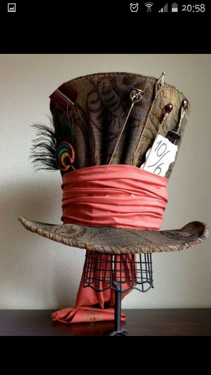 a hat with feathers on it sitting on top of a table