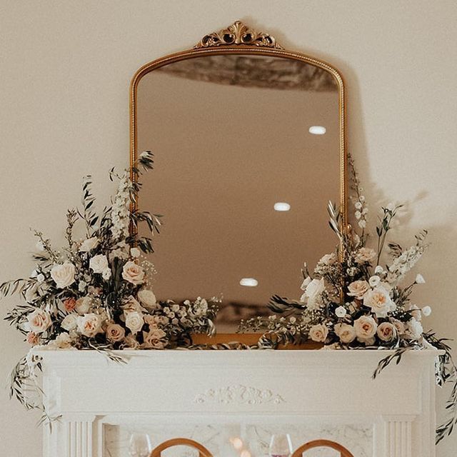 a fireplace decorated with flowers and candles