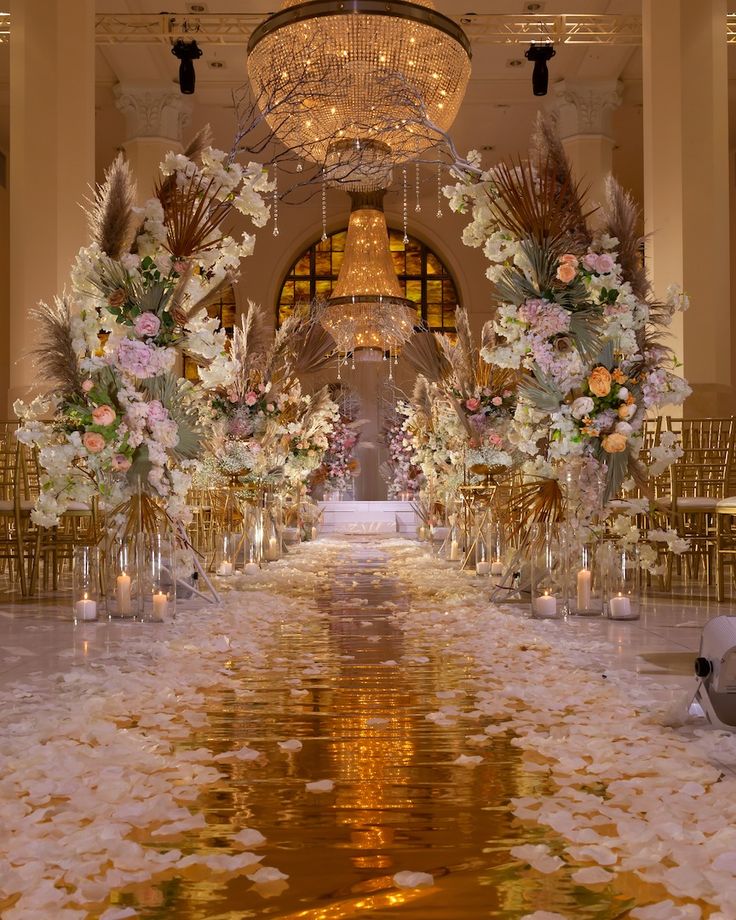 the aisle is decorated with flowers and candles