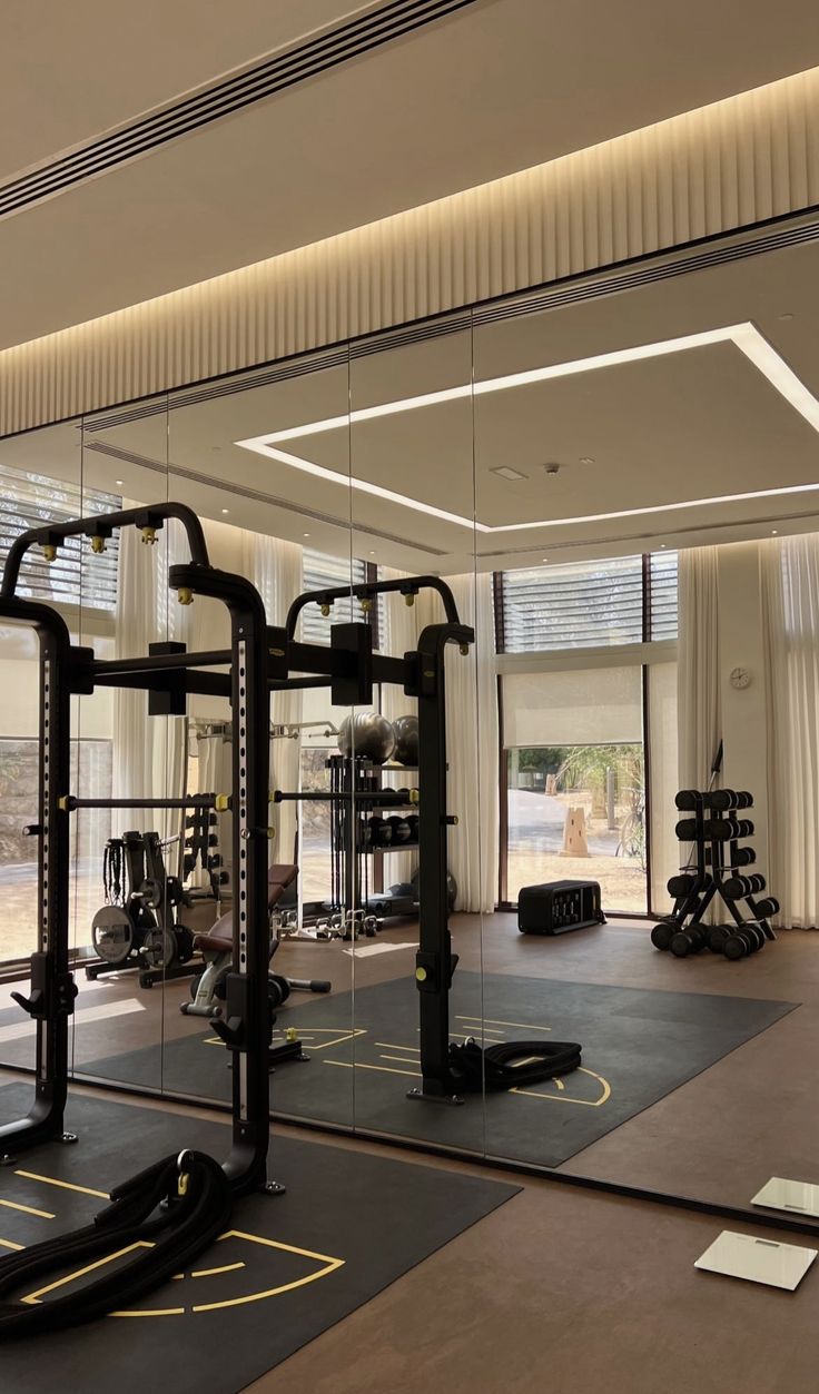 an empty gym with mirrors and exercise equipment