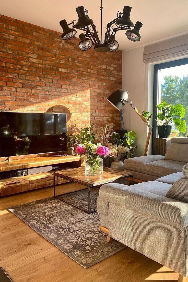 a living room filled with furniture and a flat screen tv sitting on top of a wooden table