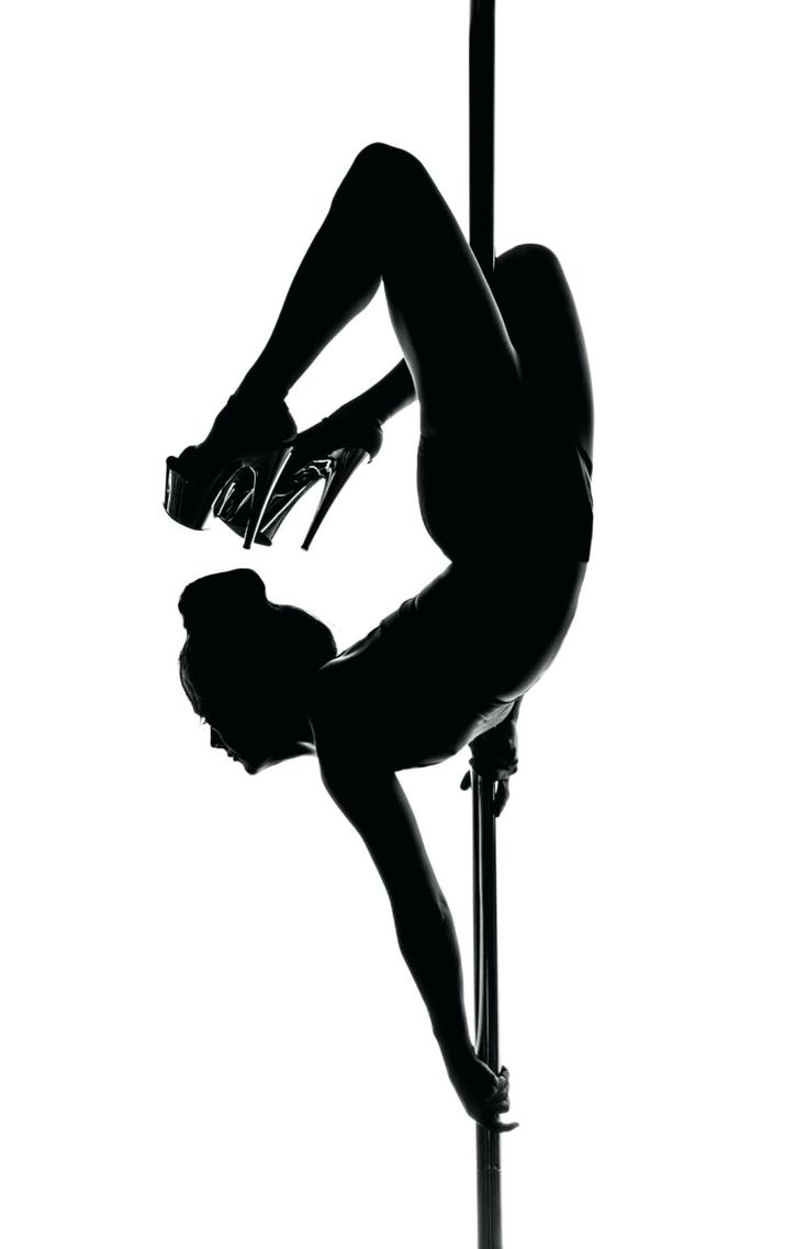 a woman is doing pole dancing in silhouette