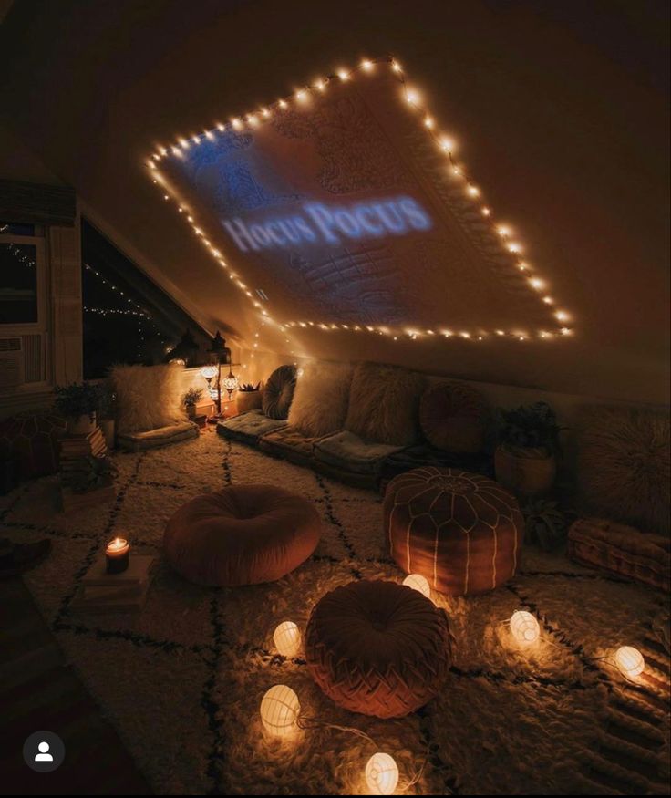 a room that has some lights on the ceiling and candles in front of it,