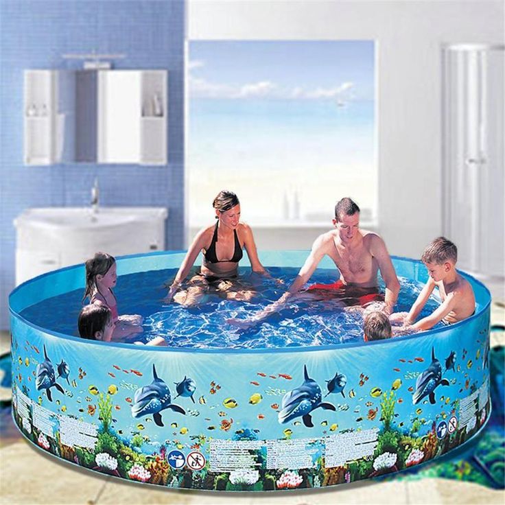 an inflatable swimming pool with dolphins and people sitting on the bottom is shown