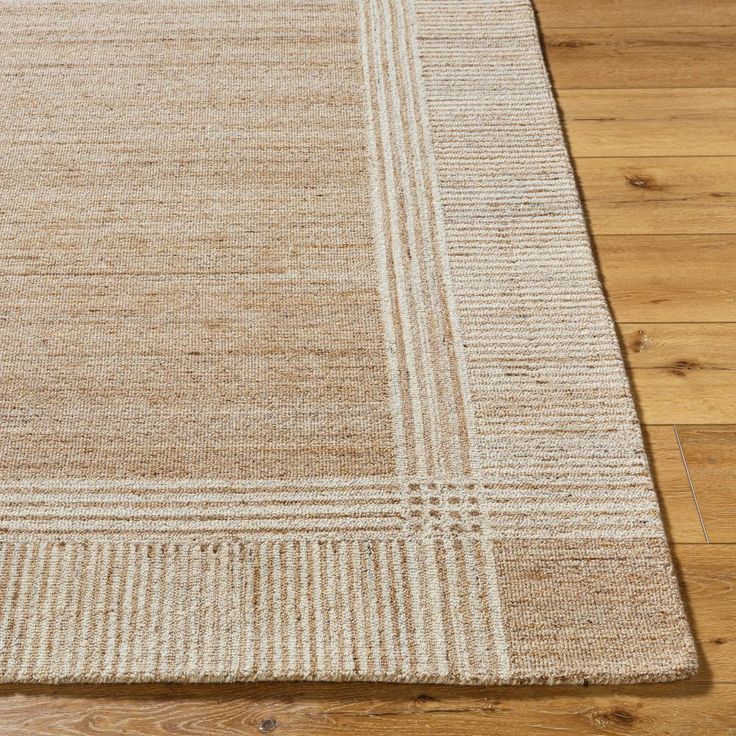 an area rug on the floor with wooden floors and wood planks in the background